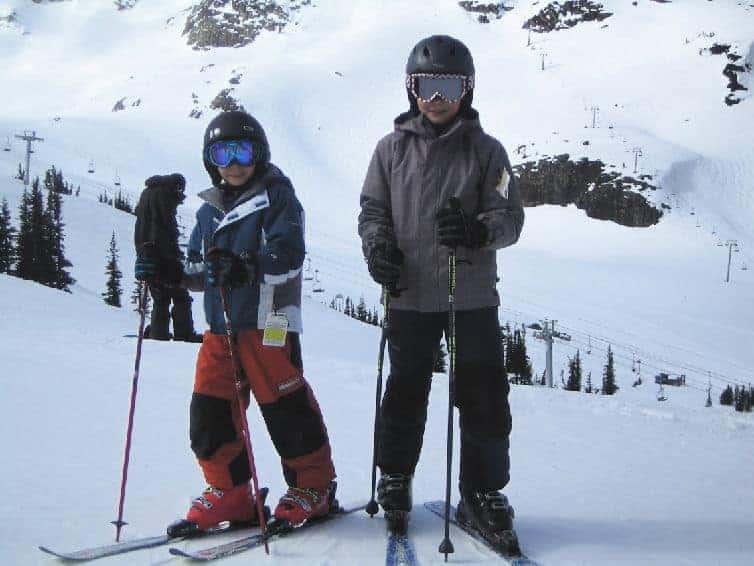 boys posing on ski hill in whistler with kids