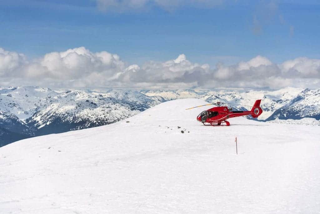 helicopter on snowy mountain in whistler