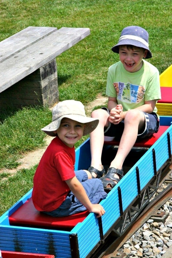 two boys sitting in model train in bern switzerland