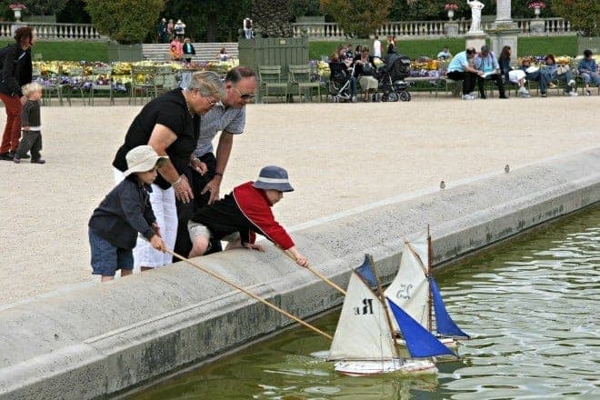 Multigenerational travel fun for all family members. Punting boats in the grande bassin in Luxembourg Gardens..