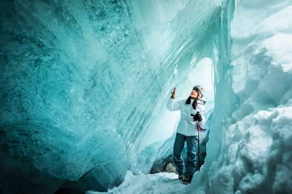 woman exploring ice cave in whistler