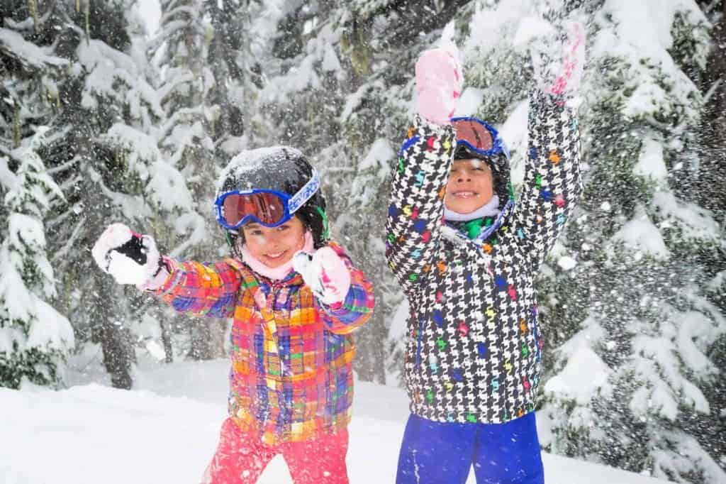 kids throwing snow in whistler in winter