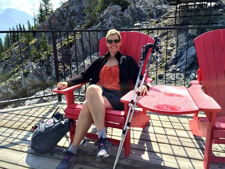 lady seated in parks canada red chair