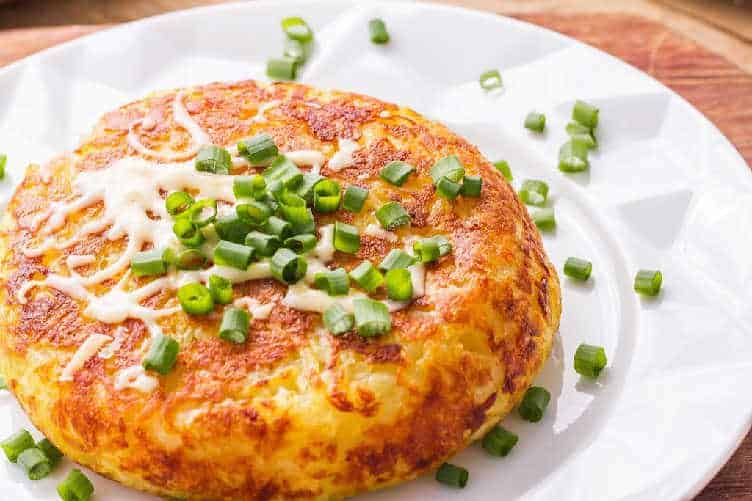 fried potato roesti topped with green onions
