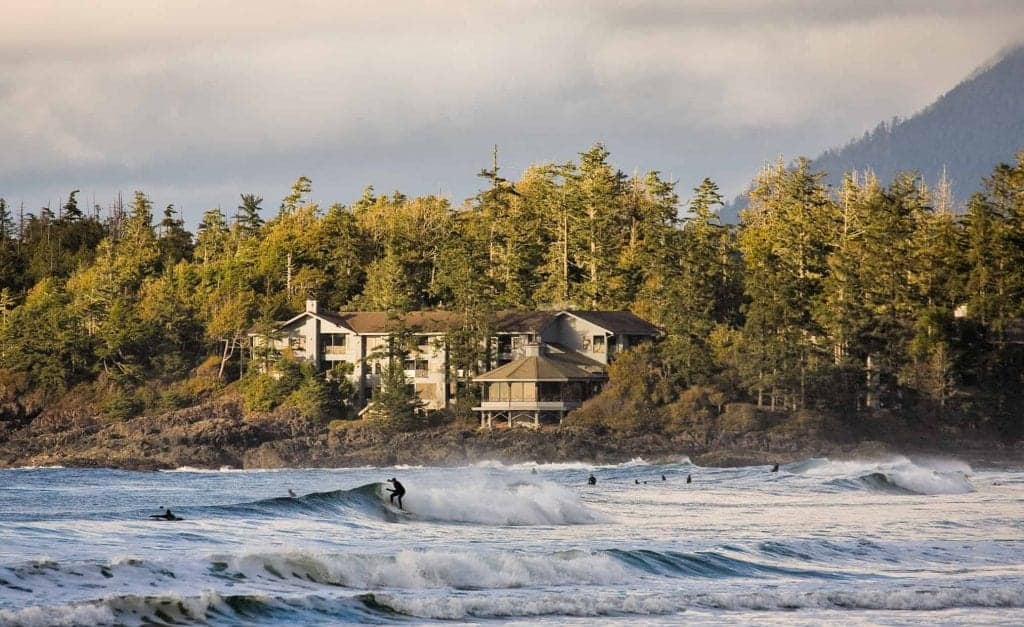 surfer riding waves in tofino 