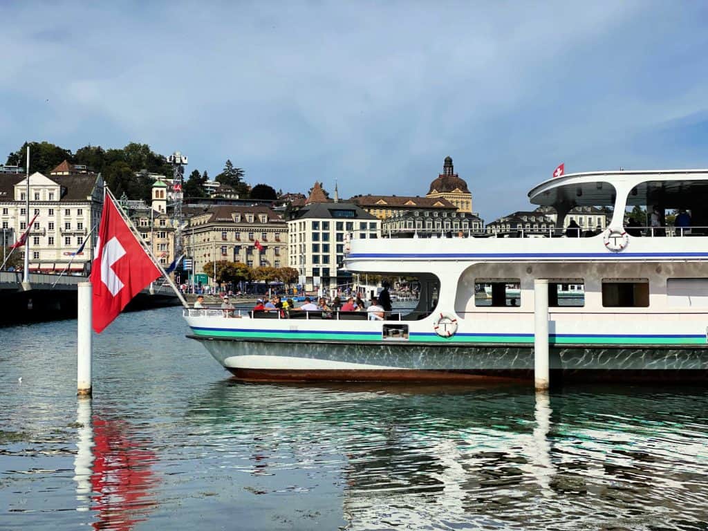 boat with swiss flag on lake lucerne
